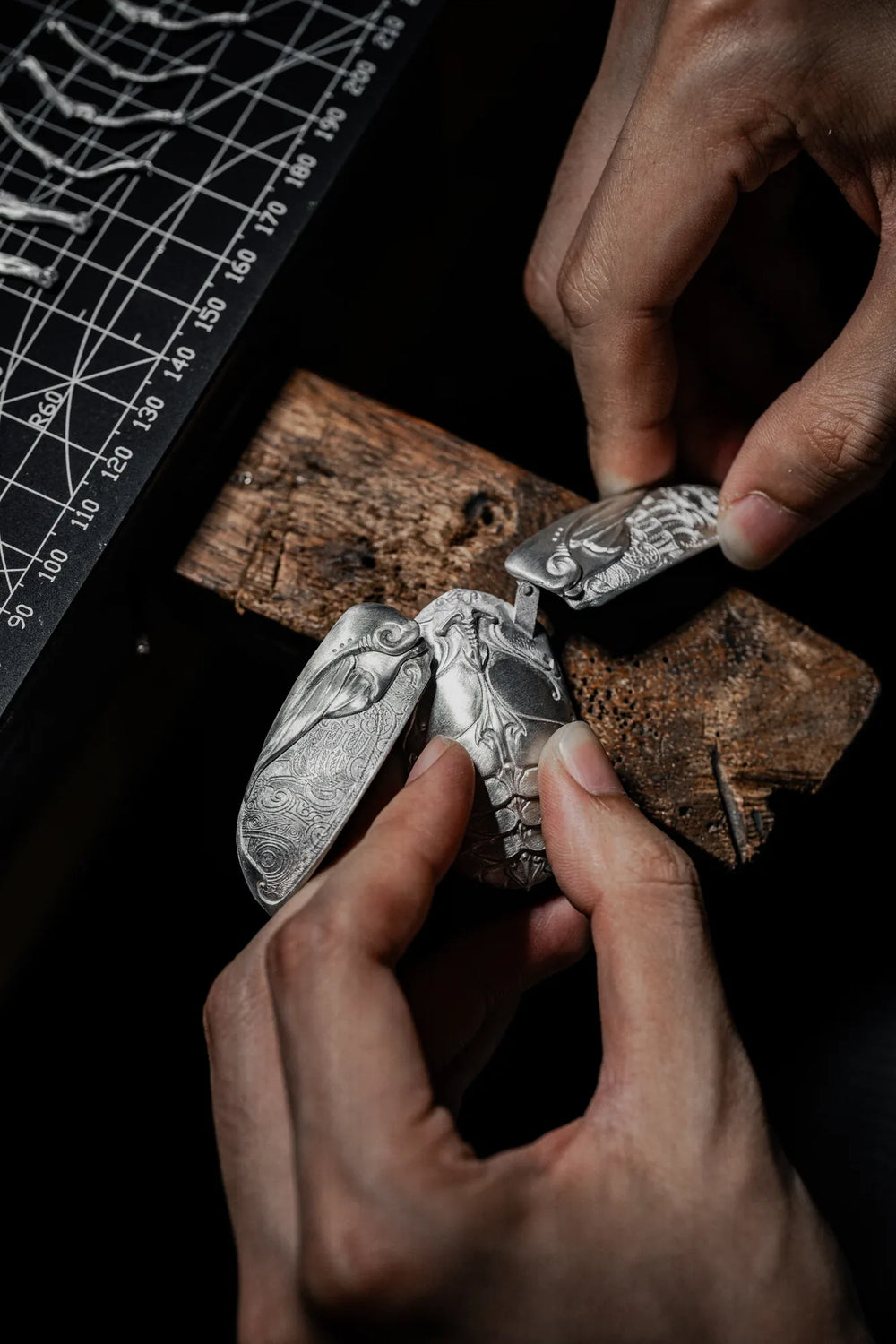 An artisan works by hand on a Ghostface Beetle component