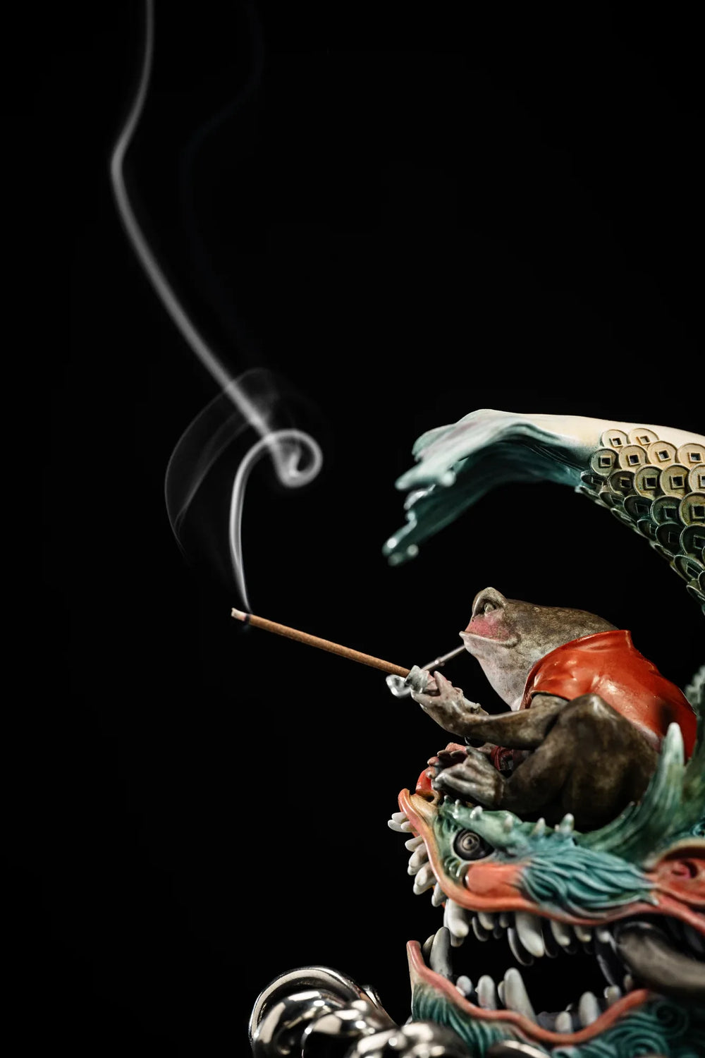 Incense smoke emerging from the pipe of the Chiwen Toad sculpture