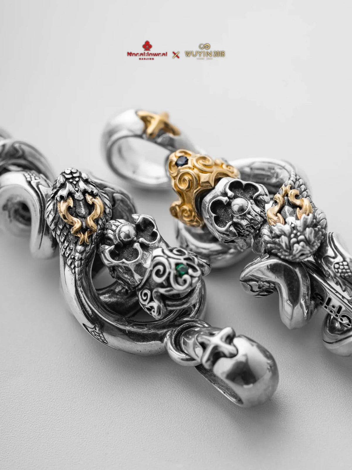 Close-up of serpent-shaped silver jewelry from the WUYIN × NOCAL:LOWCAL collaboration
