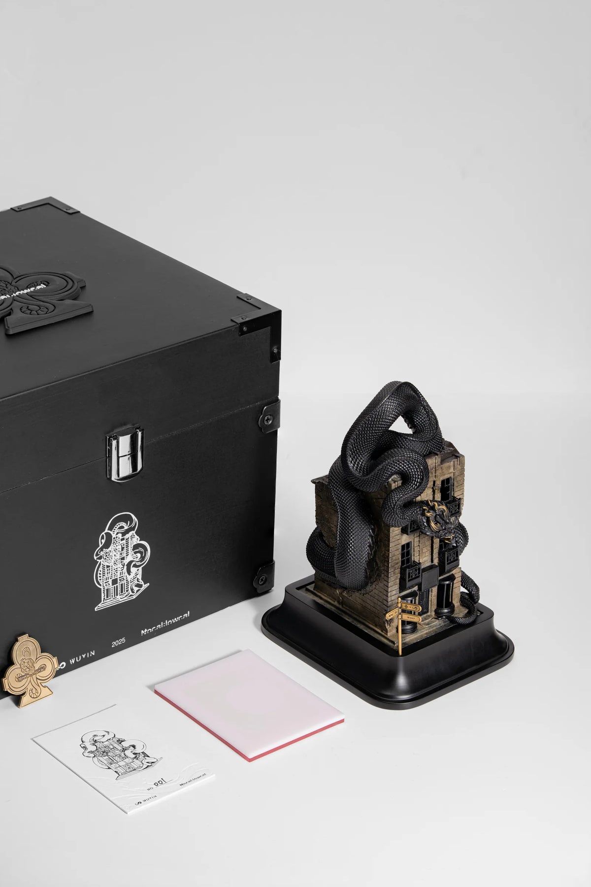 WUYIN x NOCAL:LOWCAL serpent house sculpture displayed with its presentation box and printed materials.