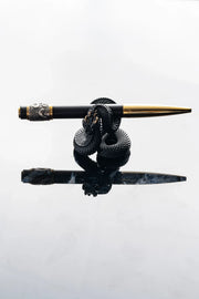 Xuegu × Bixia × WUYIN pen resting horizontally on a serpent-shaped stand against a white background