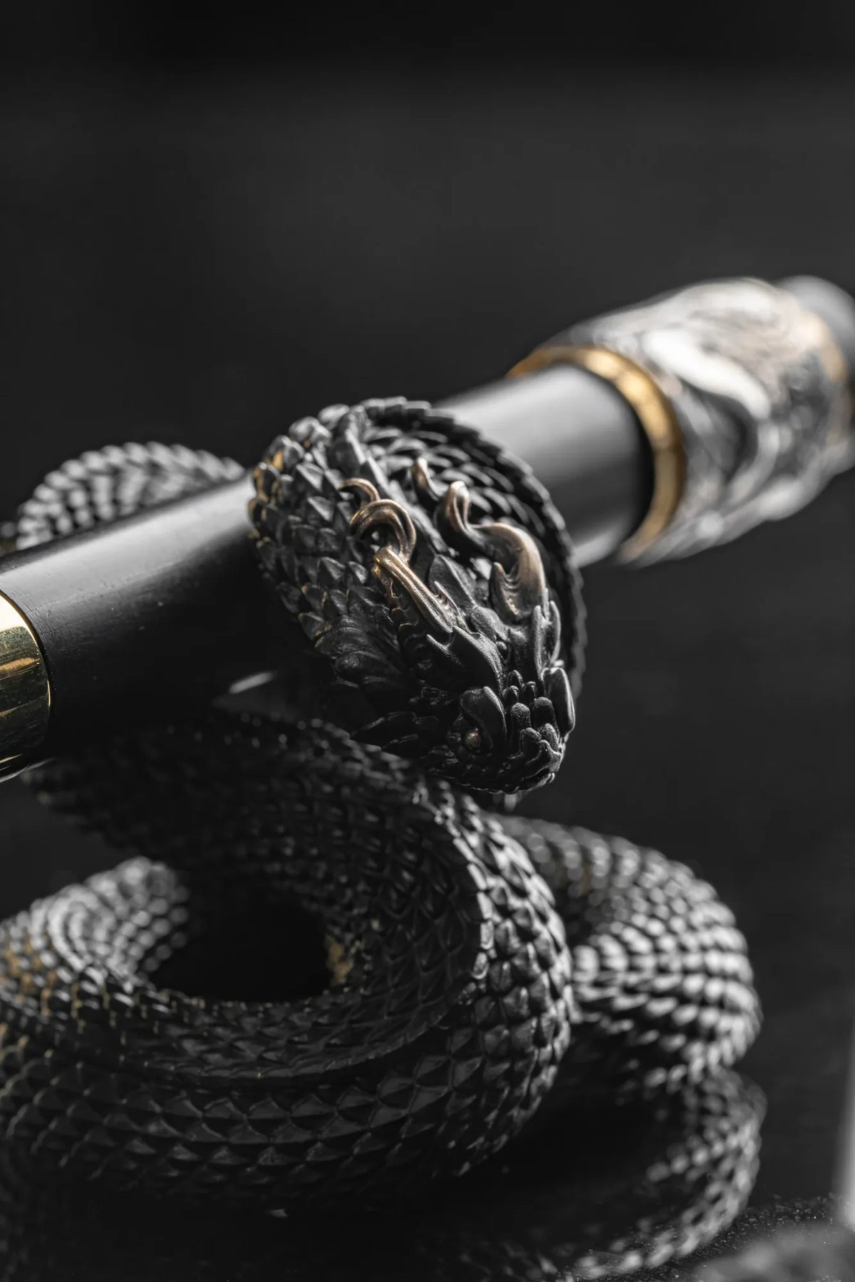 Details of the scales on the serpent-shaped pen stand and decoration on the pen barrel