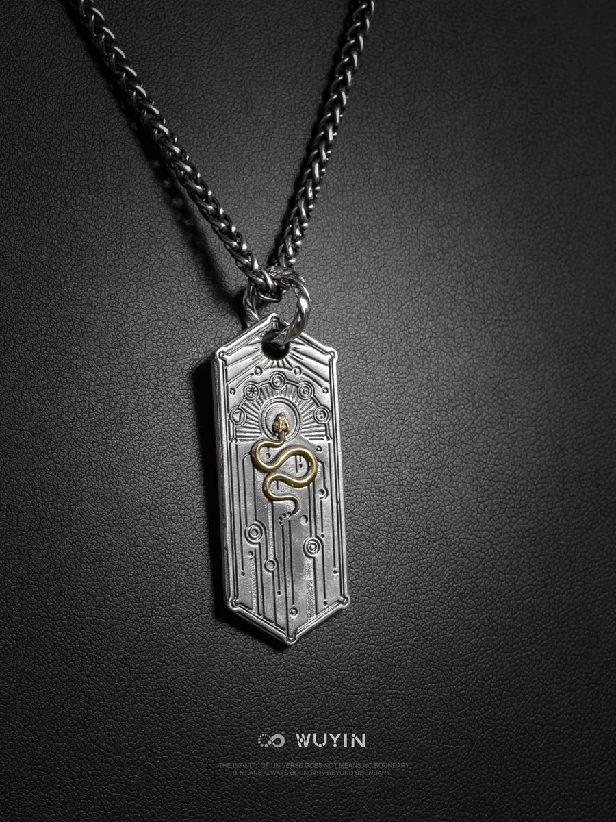 WUYIN silver amulet with a golden serpent and celestial details on a dark textured background