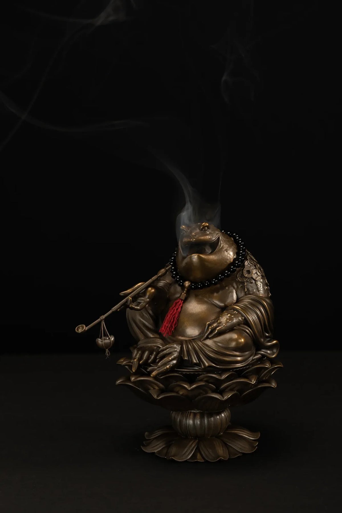 Front view of the Maitreya Toad incense burner with smoke rising from the sculpture