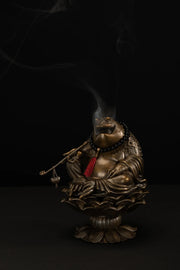 Front view of the Maitreya Toad incense burner with smoke rising from the sculpture